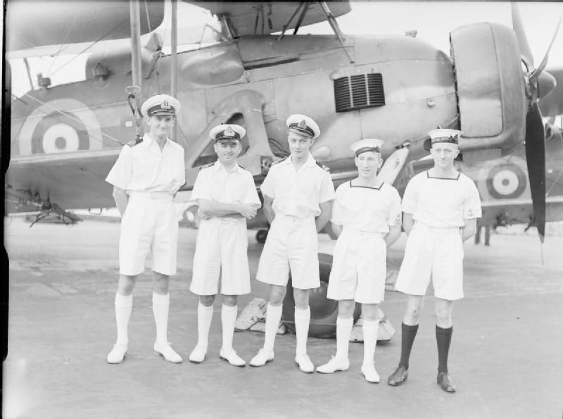 IWM photo A 5826 of aircrew of 825 Squadron Fleet Air Arm decorated for their participation in the action against the Bismarck, April 1941, including Lt Gick, the tall officer to the left