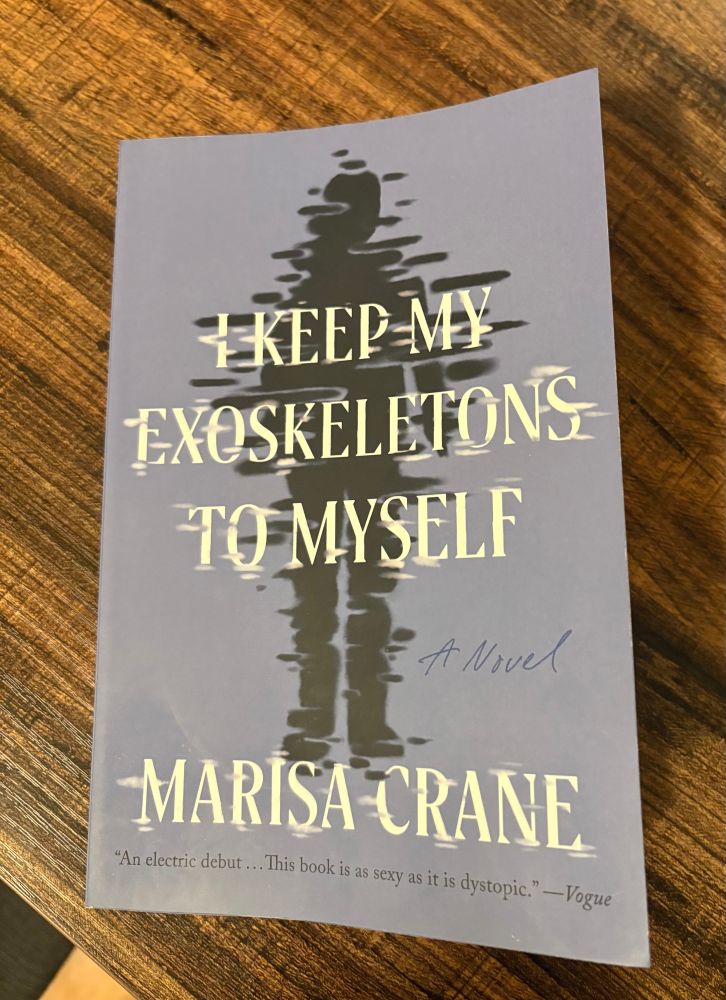 Book on table: I KEEP MY EXOSKELETONS TO MYSELF by Marisa Crane 