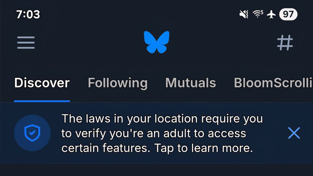 A bsky screenshot with an alert saying "The laws in your location require you to verify you're an adult to access certain features. Tap to learn more"