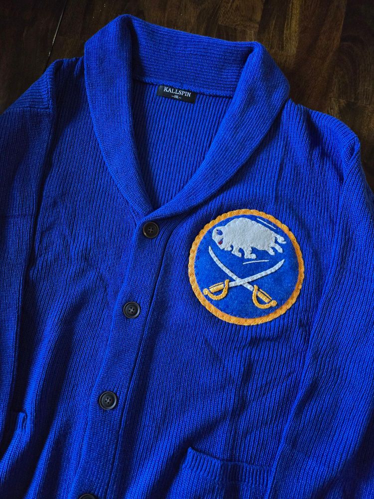 Royal blue buffalo sabres cardigan with the bison and sabres logo on chest