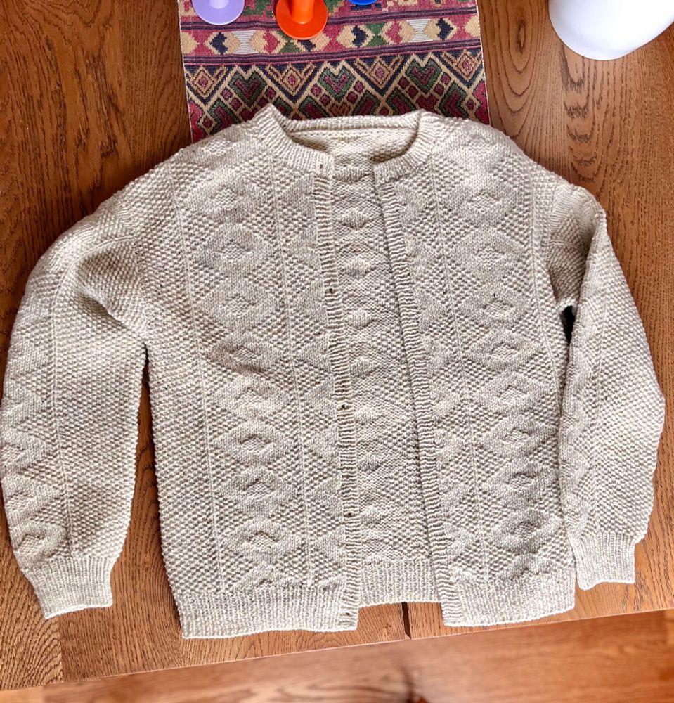Esther Jacket sweater laid out on table blocking.
