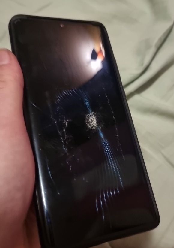 Phone with cracks radiating from impacted point
