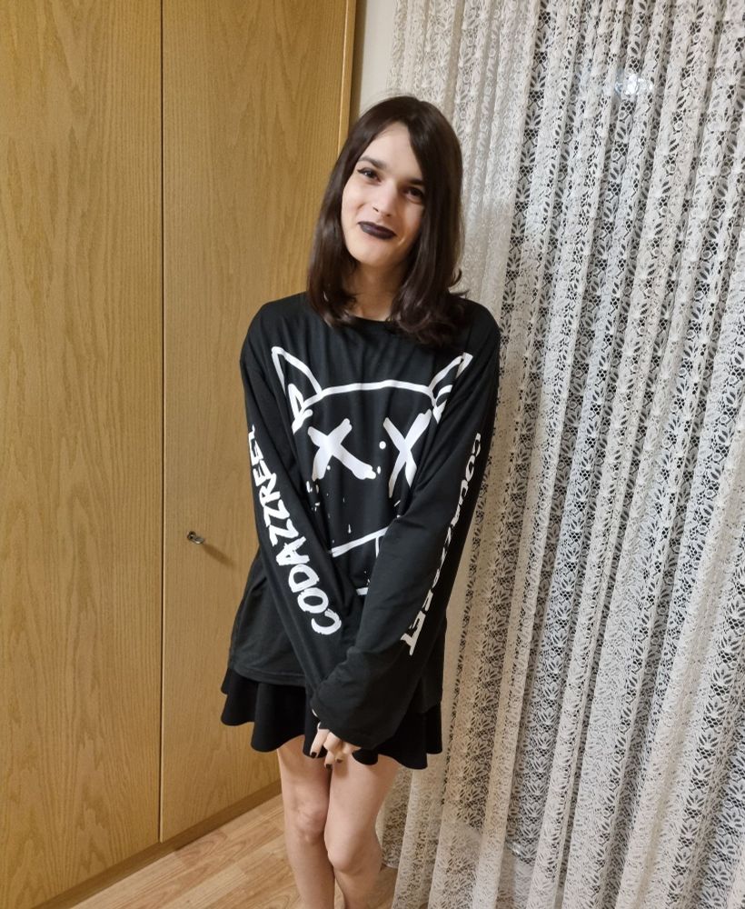 A pic of me with my makeup done, with black nail polish, a black skirt and a black oversized shirt