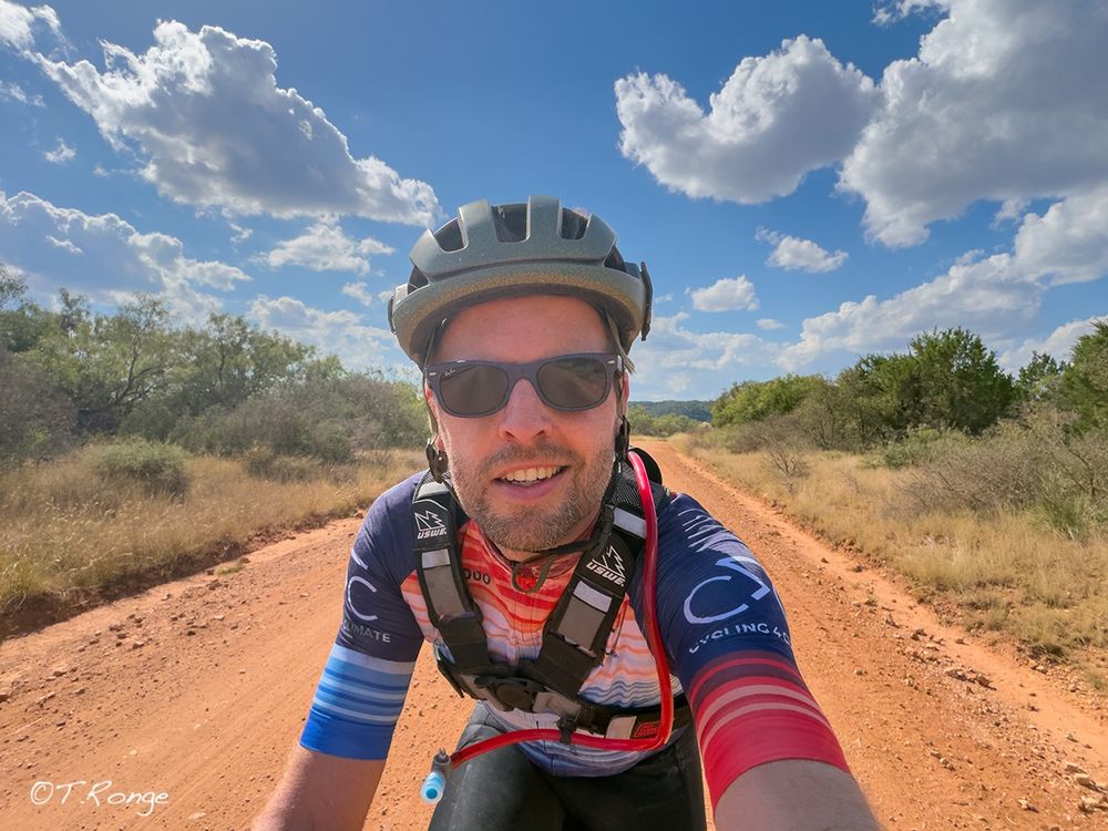 Cyclist in a climate stripes jersey.