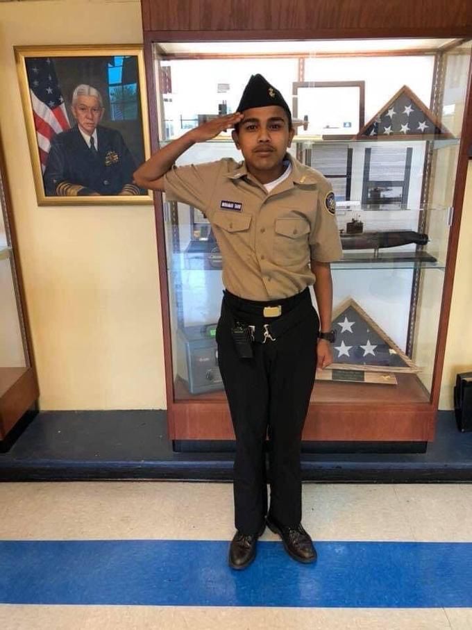 Photo of a Boy Scout saluting and standing at attention