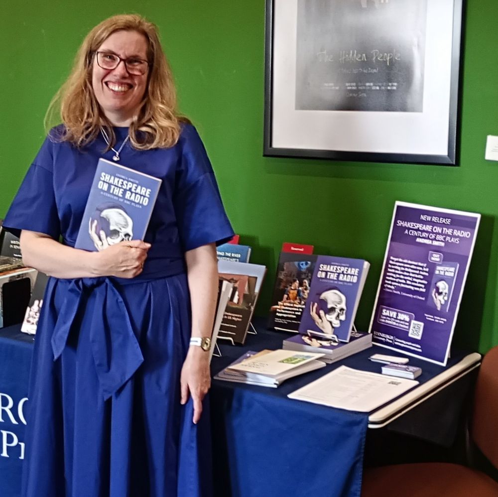 Andrea standing in front of the stand holding the book: Shakespeare On The Radio 