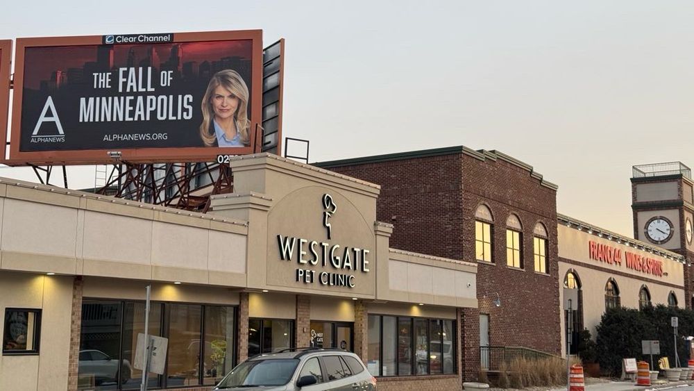 Billboard for “the fall of Minneapolis” above France 44 wine and cheese shop