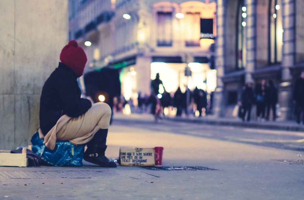 Person sitting beside building looking straight to the street at golden hour.
Thank you to Ev on Unsplash for this image.