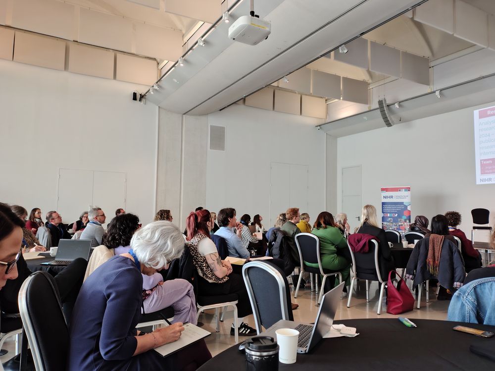 Image of a room of people attending a research showcase