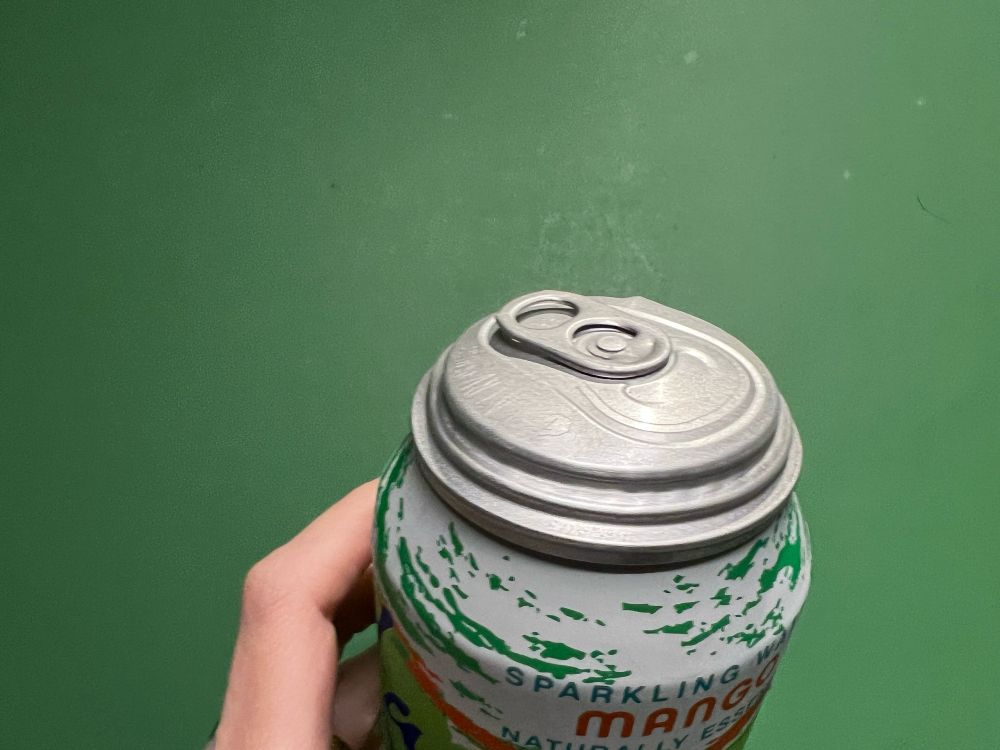 A can of mango La croix but the top is really puffy like it’s about to explode
