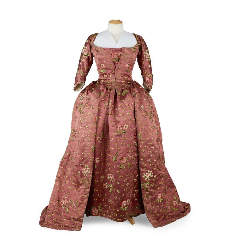 From the catalogue: 'altered circa 1780 to a robe à la polonaise style, of dark plum (purple/brown) coloured silk with small brocade flower sprigs all over interspersed with larger floral sprays, high square neckline at the back and an open front, with attached panel without stomacher, three quarter length sleeves and full long skirt, the inside part lined on the front edges and the hem of skirt in green silk and linen, some further later alterations.' Has been on long-term loan to the Royal Collection at Holyroodhouse for almost a century, featured in the big Jacobite exhibition @ntlmusuemsscot.bsky.social in 2017, now being sold by Lord Airlie