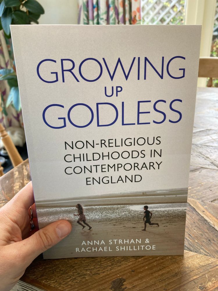 Book cover showing two children running at a beach