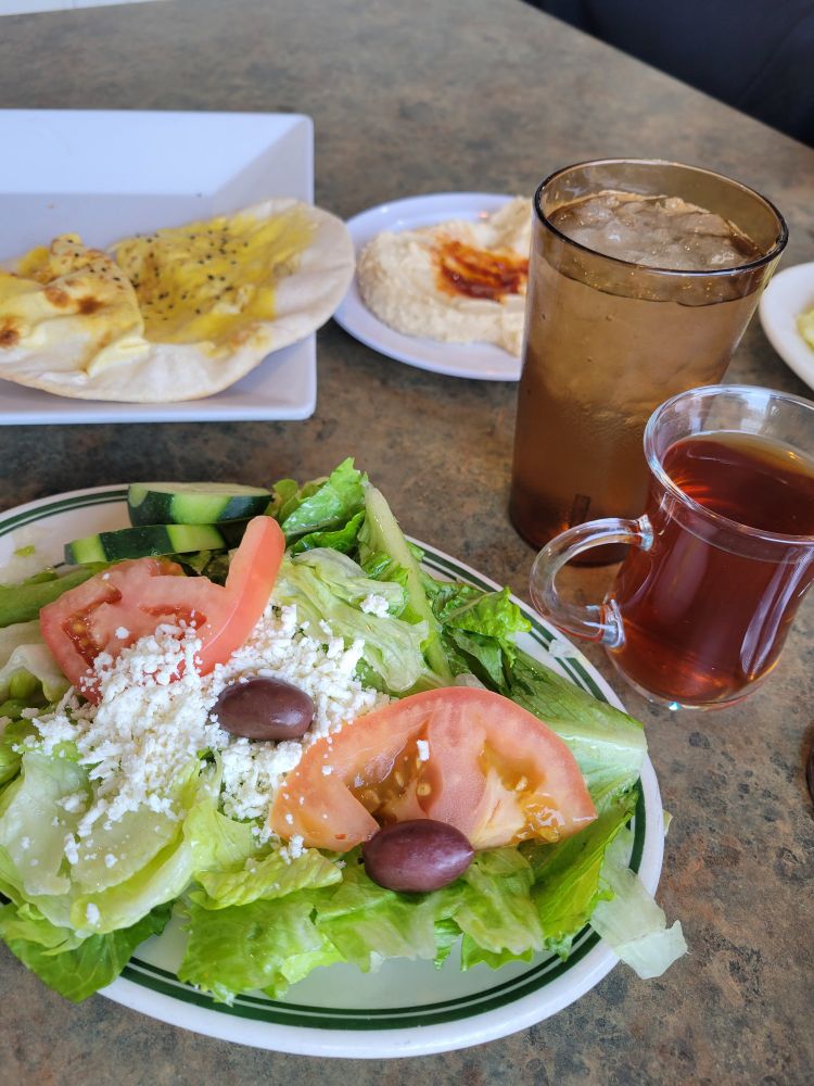 Turkish balloon bread, hummus, salad (lettuce,  tomato, olives feta), water, hot tea.