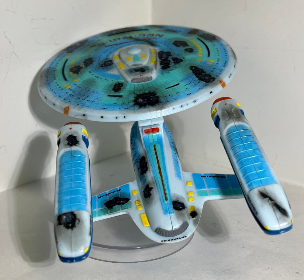 Back view of the smaller model of Ambassador, battle damaged and decal’d as the Enterprise C.