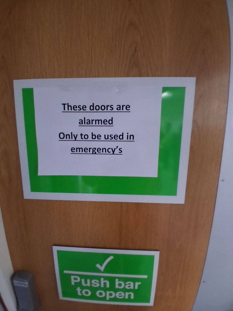 Notice saying Doors are only to be used in   emergency's  (sic)