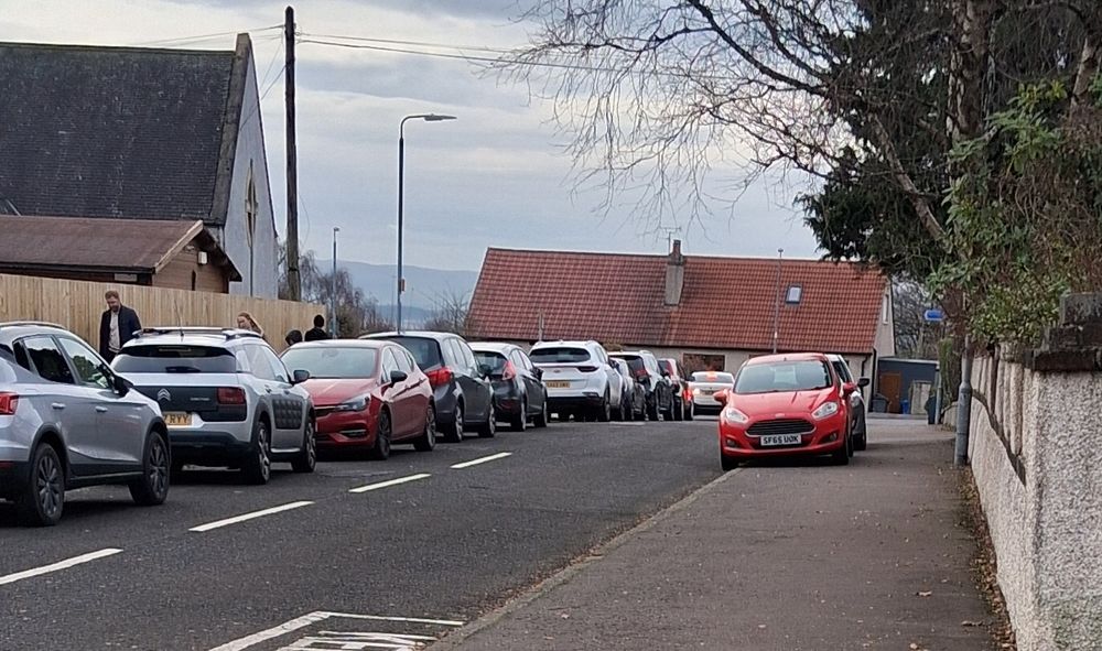 Most drivists parked legally, two on the opposite pavement 