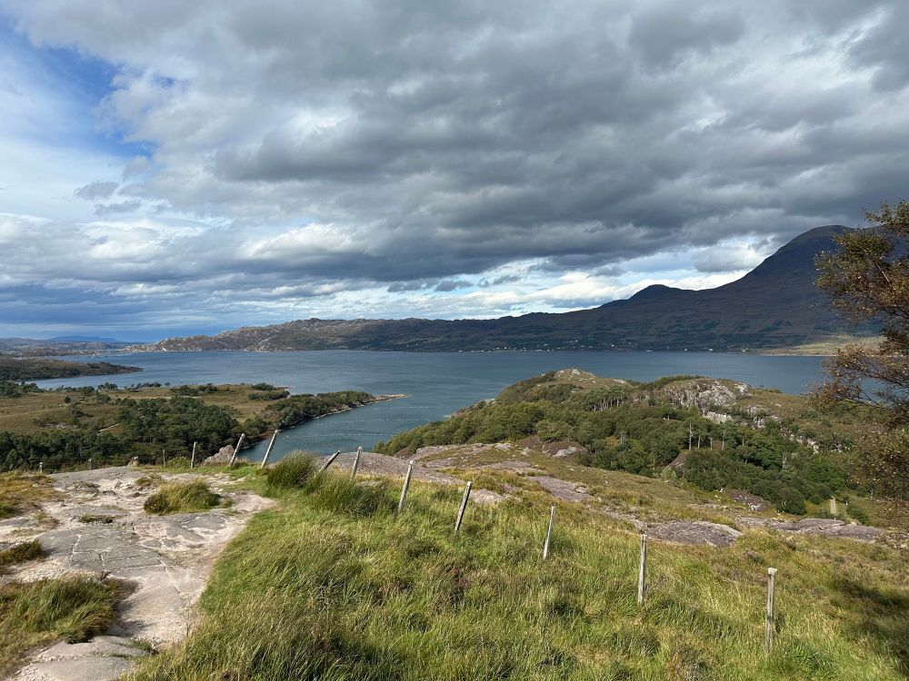 Ein See, Berge, davor karge Wiese 