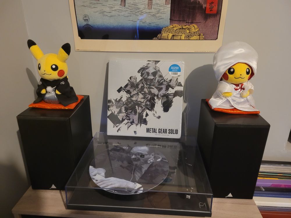 Vinyl box set of Metal Gear Solid saga on a vinyl turntable. We can see Jacques Chirac on the slipmat.