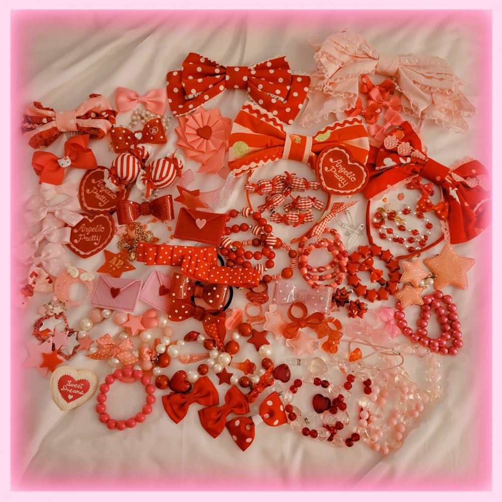 A pile of 20+ bows, 20+ bracelets, 3 necklaces,  and various rings and pins on pink and red. 