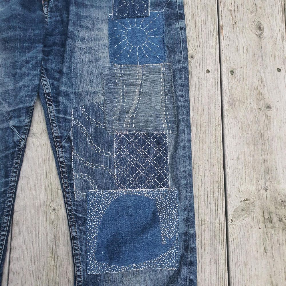 Sashiko inspired mendings on a pair of jeans.