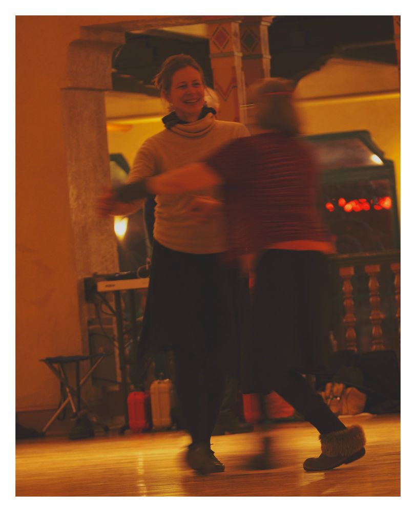 Two people in skirts waltzing in the Spanish Ballroom at Glen Echo.