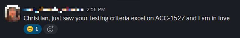 A Slack message with the sender's profile picture and name pixelated. The message reads: “Christian, just saw your testing criteria excel on ACC-1527 and I am in love” and is timestamped at 2:58 PM. There is a smiley face emoji reaction with a count of 1 below the message.