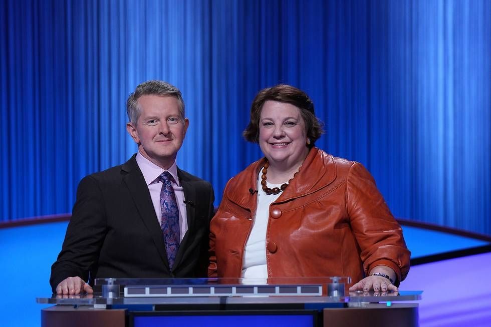 A photo of Ken Jennings and me behind my Jeopardy podium. Ken is in a dark suit and I'm in a rust jacket with a white shirt underneath 