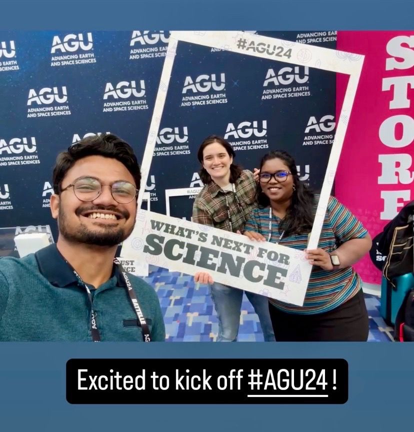 3 people smiling and posing with a sign that says “What’s next for science”.