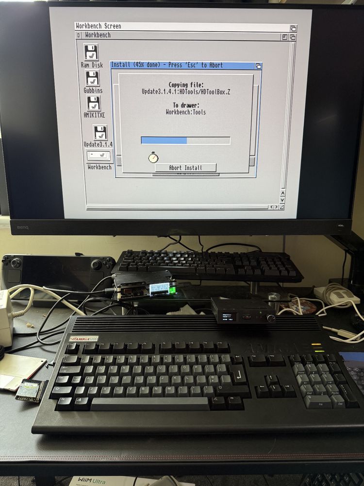Commodore Amiga 1200 in a black case with black and gray keycaps connected to a monitor using an OSSC