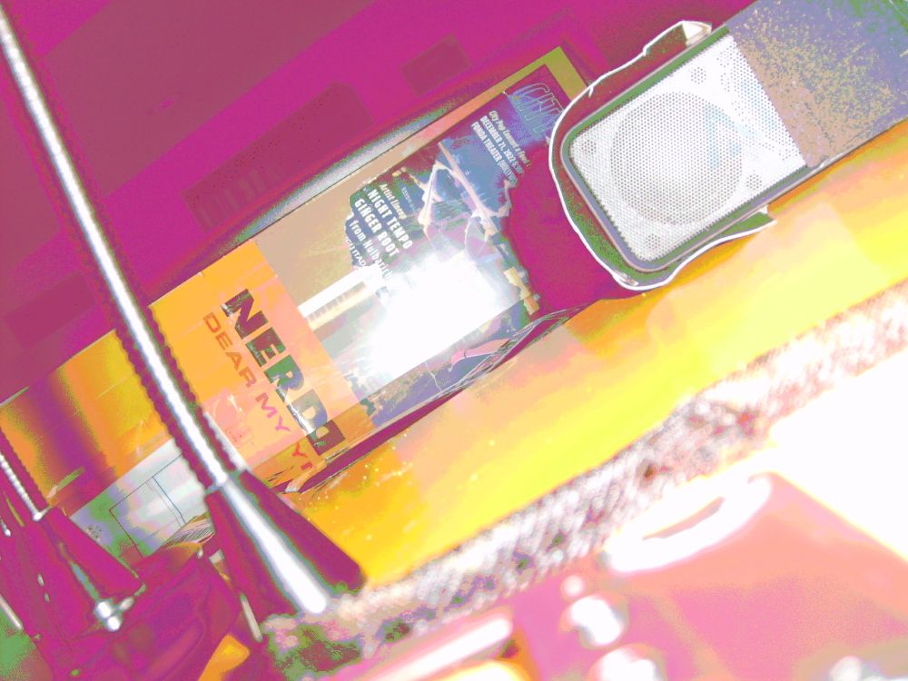A picture taken by the digicam in the above posts while shorting two pins, artificating the image. The most obvious change is the shadows are glitching magenta. The flash of the camera hitting the black bendy arm shows the grade go from white to green to a very dark purple right before it gets to the darkest part where it turns to a much brighter magenta.