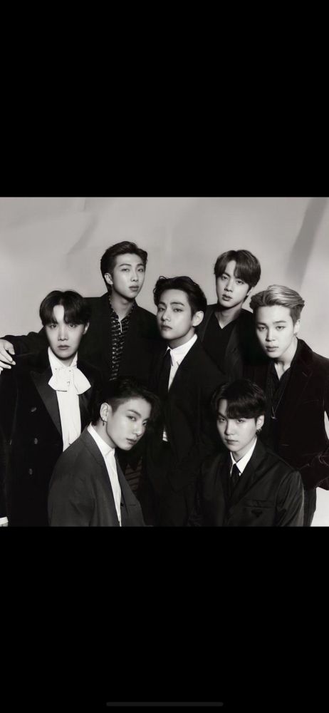 black and white of our seven guys, looking sharp and devastatingly handsome in black suits. Taehyung in the center, and clockwise from the 1 o’clock position is Jin, Jimin, Yoongi, Jungkook, Hoseok, and Namjoon