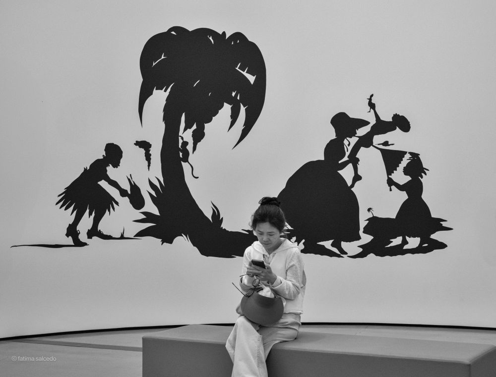 Lady sitting by some modern art 