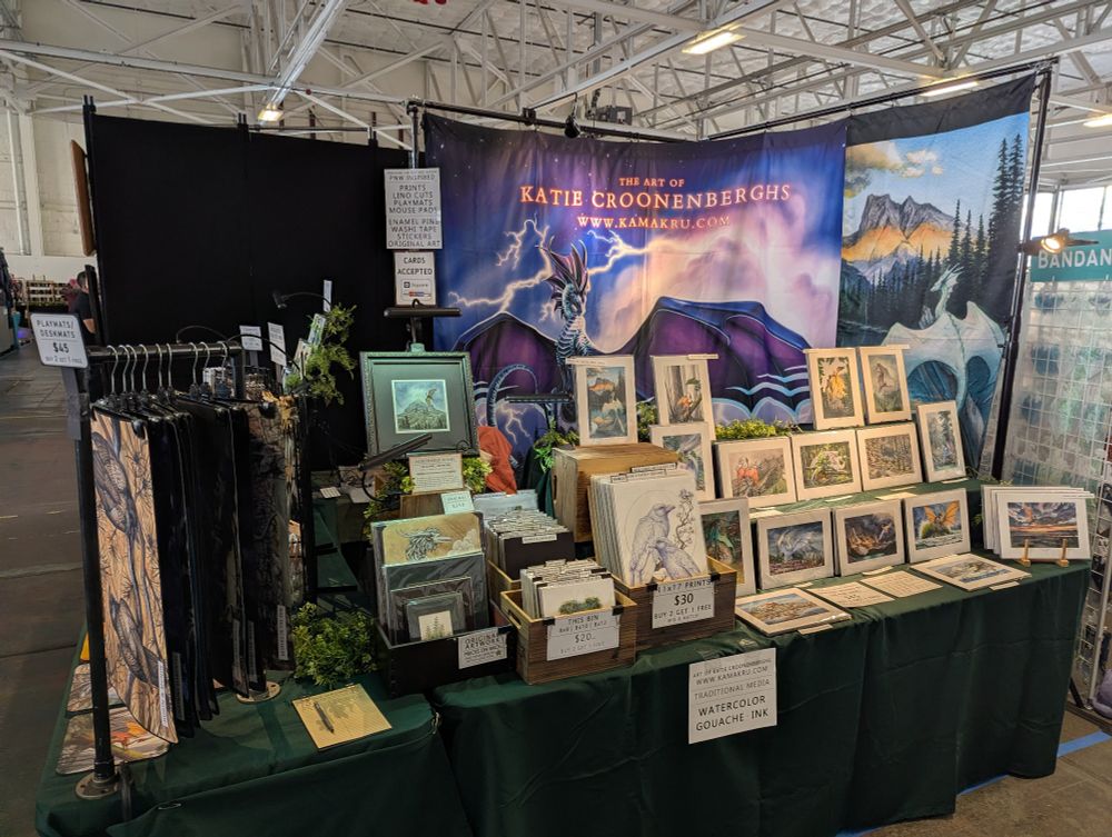 A photo of the booth with banners that read art of Katie croonenberghs 