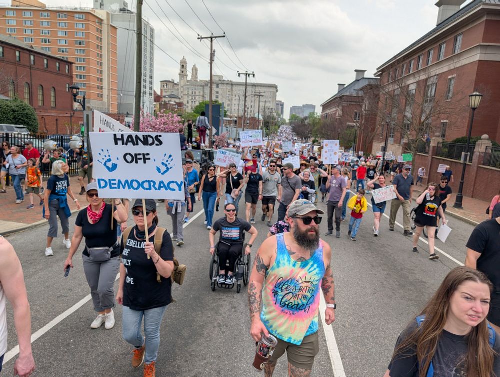 Looking East on Main Street at a crowd of people marching from the Capitol to Monroe Park.