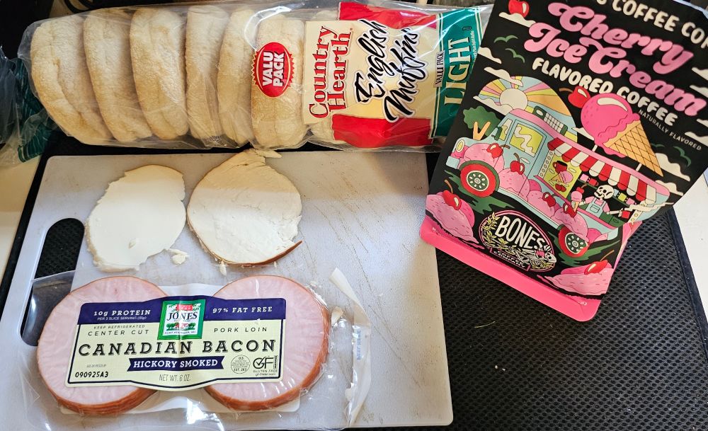Canadian bacon, slices of smoked goat gouda, a package of cherry ice cream flavored coffee, English muffins 