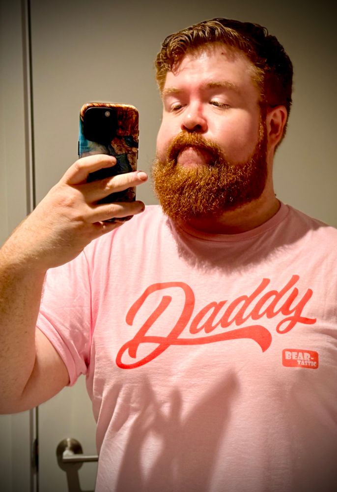 A gay ginger bear with a pink t-shirt that says ‘Daddy’.