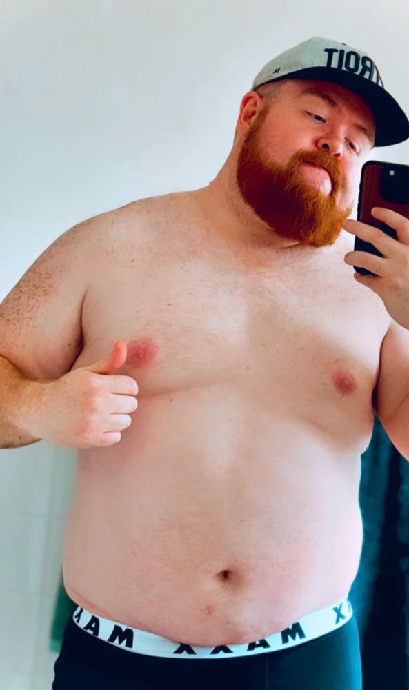 A big ol’ gay ginger bear in a cap and his underwear.