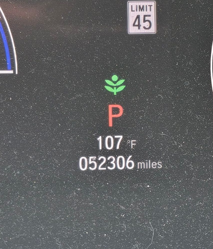 Car dashboard showing temp of 107 degrees 
