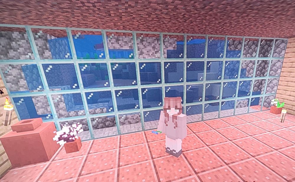 Inside view. Character is standing infront of window. Walls are wooden and floor is granite. Celieng is ground. Outlines of rock on the windows. By the walls there are planters and torches