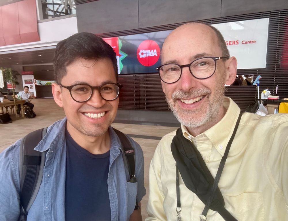 Two smiling chemists at a conference. 