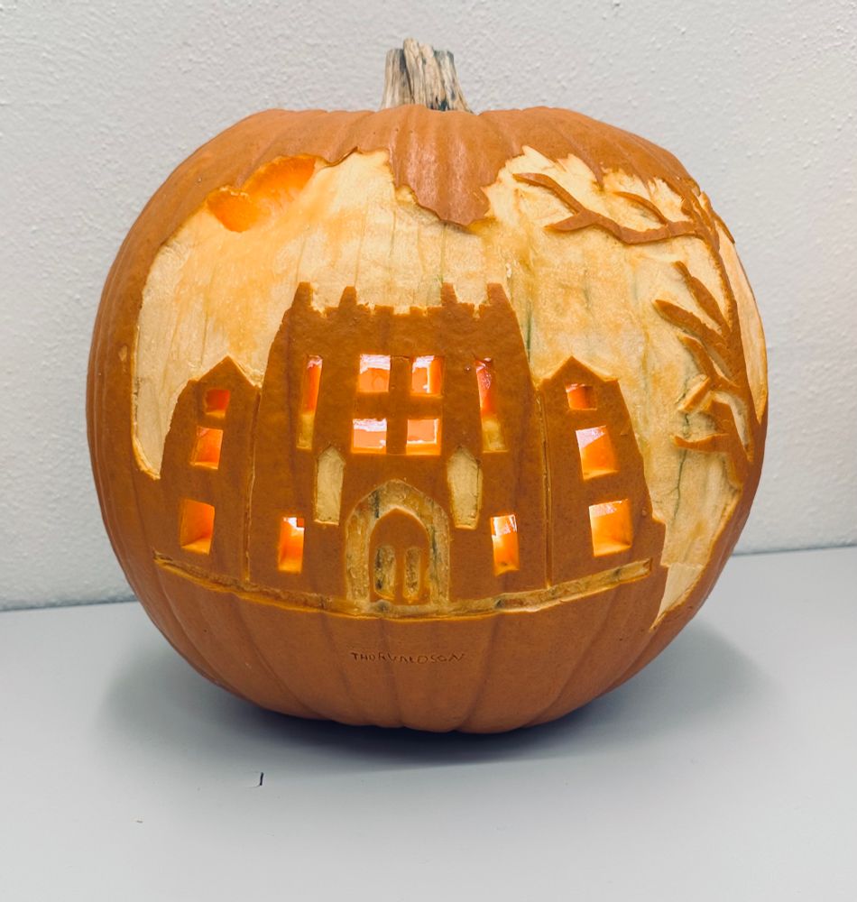 A pumpkin carved with the silhouette of the Thorvaldson Building, ancestral home of the Department of Chemistry at the University of Saskatchewan. 
