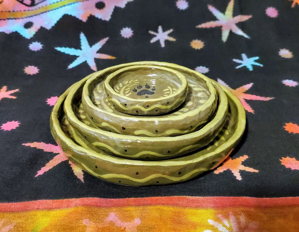 ceramic dishes stacked from largest to smallest on top 