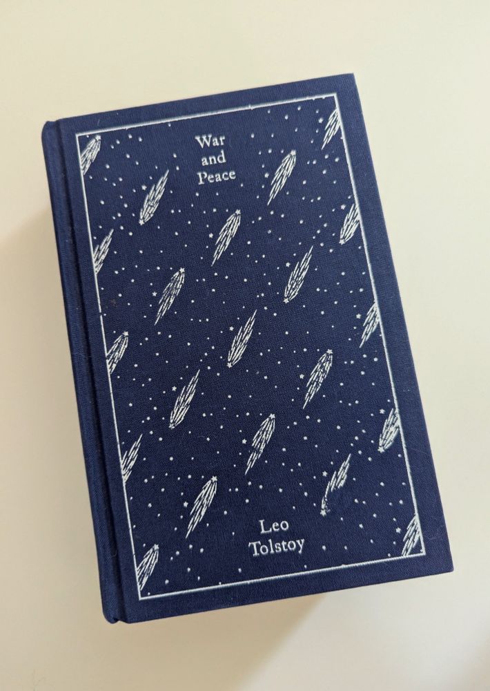 Penguin Classics copy of War and Peace, with a navy blue cloth cover with printed white comets on it. This copy is the Briggs translation.