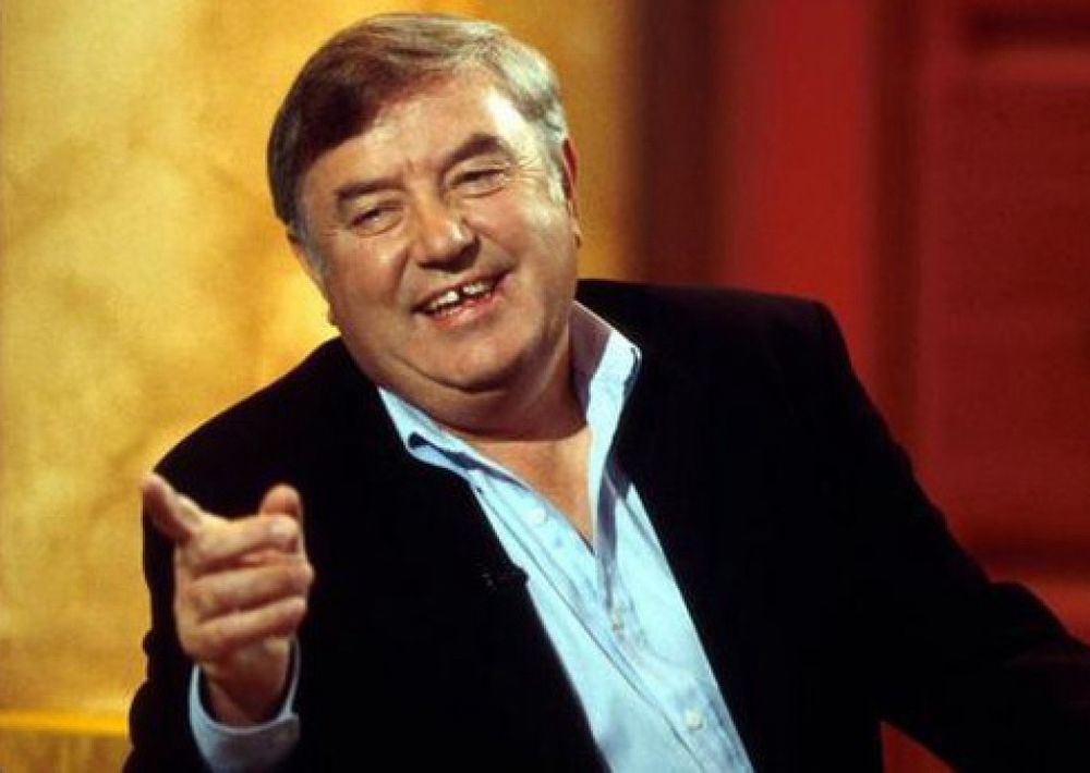 Jimmy Tarbuck pointing to the left looking like Rachel Reeves. 