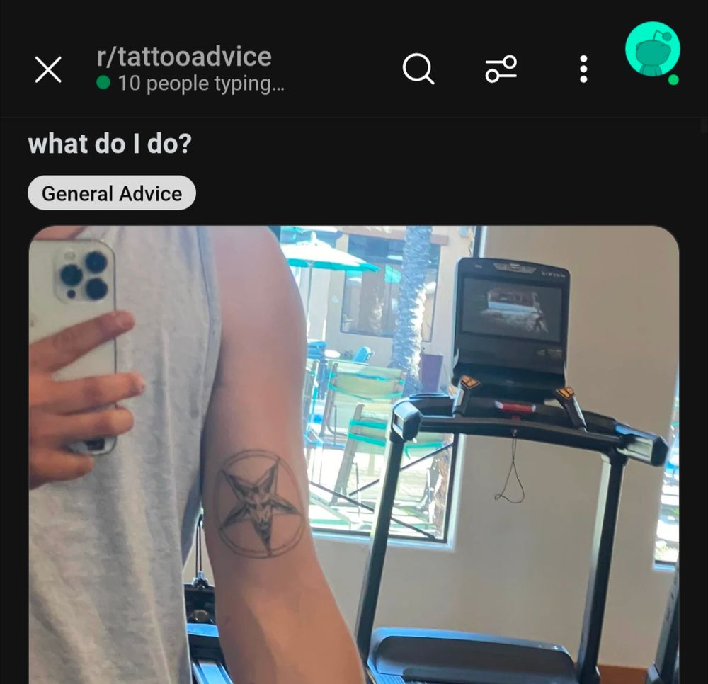 Picture posted to Reddit on the r/Tattoo advice board. Picture features a tattoo of the Sigil of Baphomet (a goats inside an inverted pentagram, with runes at each point of the star) on a young man's arm with the title "what should I do?"