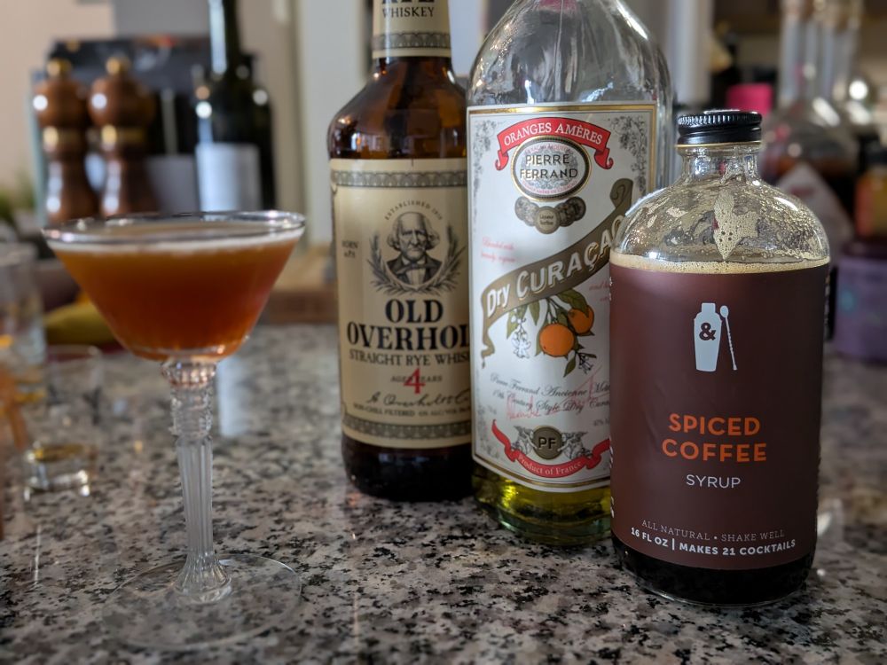 A cocktail composed of Old Overholt, Pierre Ferrand Dry Curaçao, and Spiced Coffee syrup.