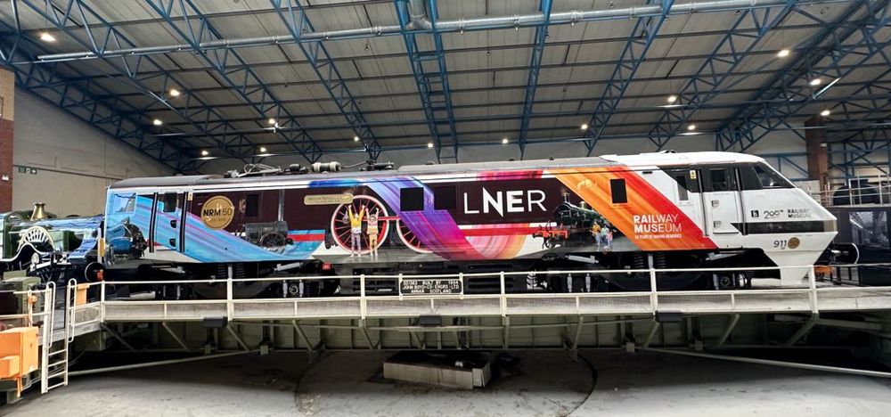 LNER class 91 locomotive 91105 (remembered 91150) on the turntable at the National Railway Museum, York, in its new livery celebrating the NRM’s 50th anniversary and with a golden nameplate “National Railway Museum 50 years 1975-2025”