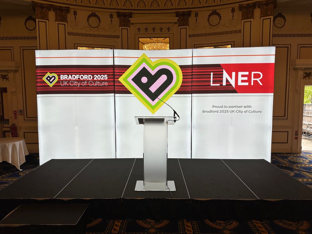 The stage set for the launch, showing the Bradford 2025 UK City of Culture and LNER logos, with text reading Proud to partner with Bradford 2025 UK City of Culture