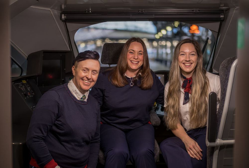 Three LNER drivers in the driving cab of an Azuma train