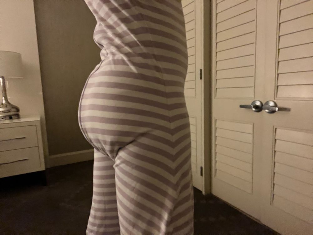A photo taken in a hotel room with my diaper bulge showing beneath my Little Keeper Sleeper pajamas